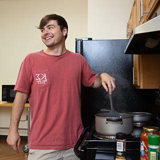 Student cooking a meal in the dorm. 
